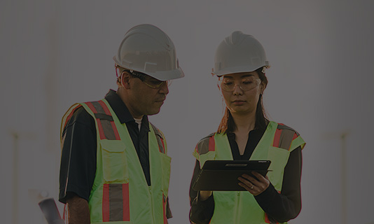 two workers looking at tablet
