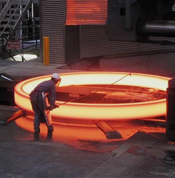 worker forming heated steel ring